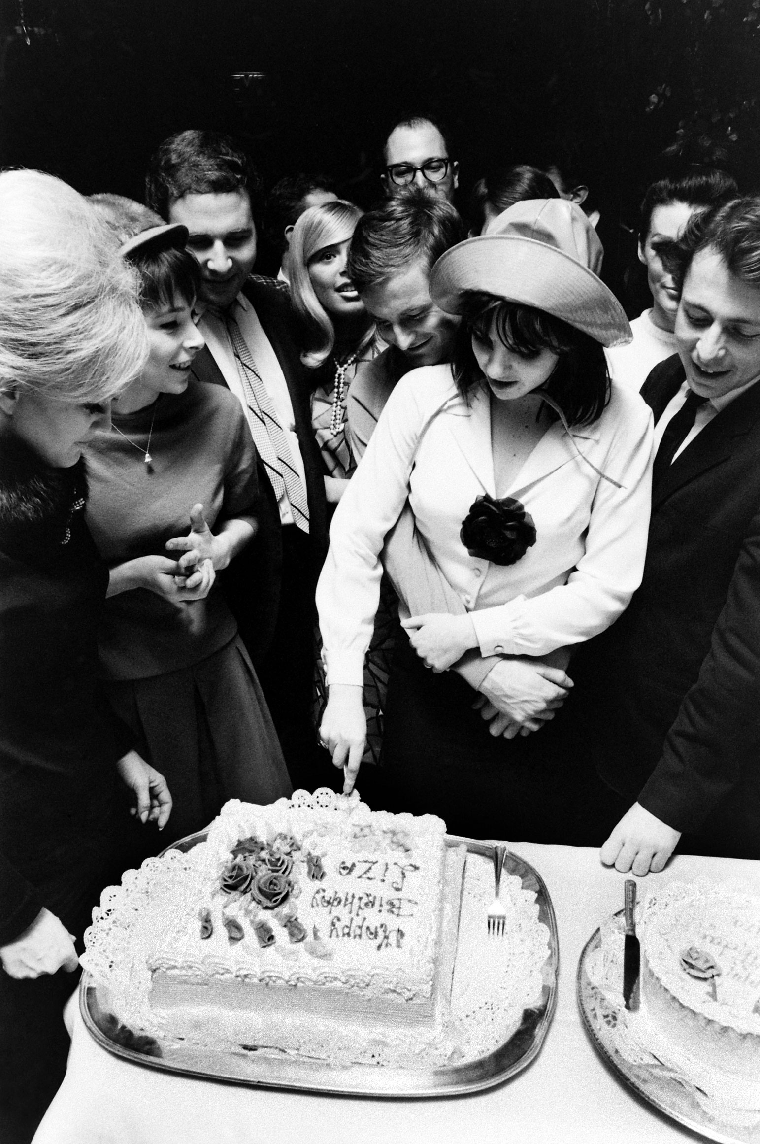 Surrounded by friends, and in the embrace of fiancé Peter Allen — she'd marry the Australian entertainer two years later — 19-year-old Liza Minnelli cuts her birthday cake in 1965.