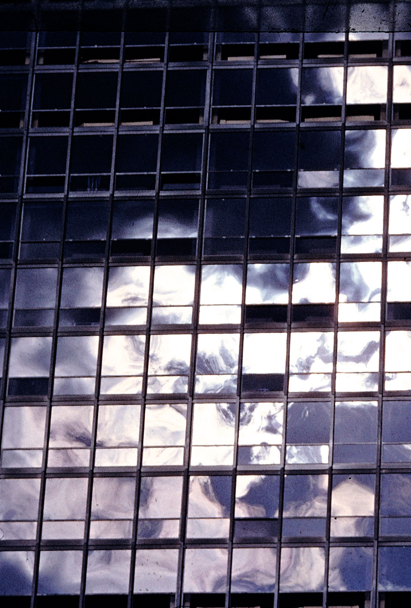 Clouds reflected on the glass facade of an apartment building in Chicago designed by Ludwig Mies van der Rohe, 1956.