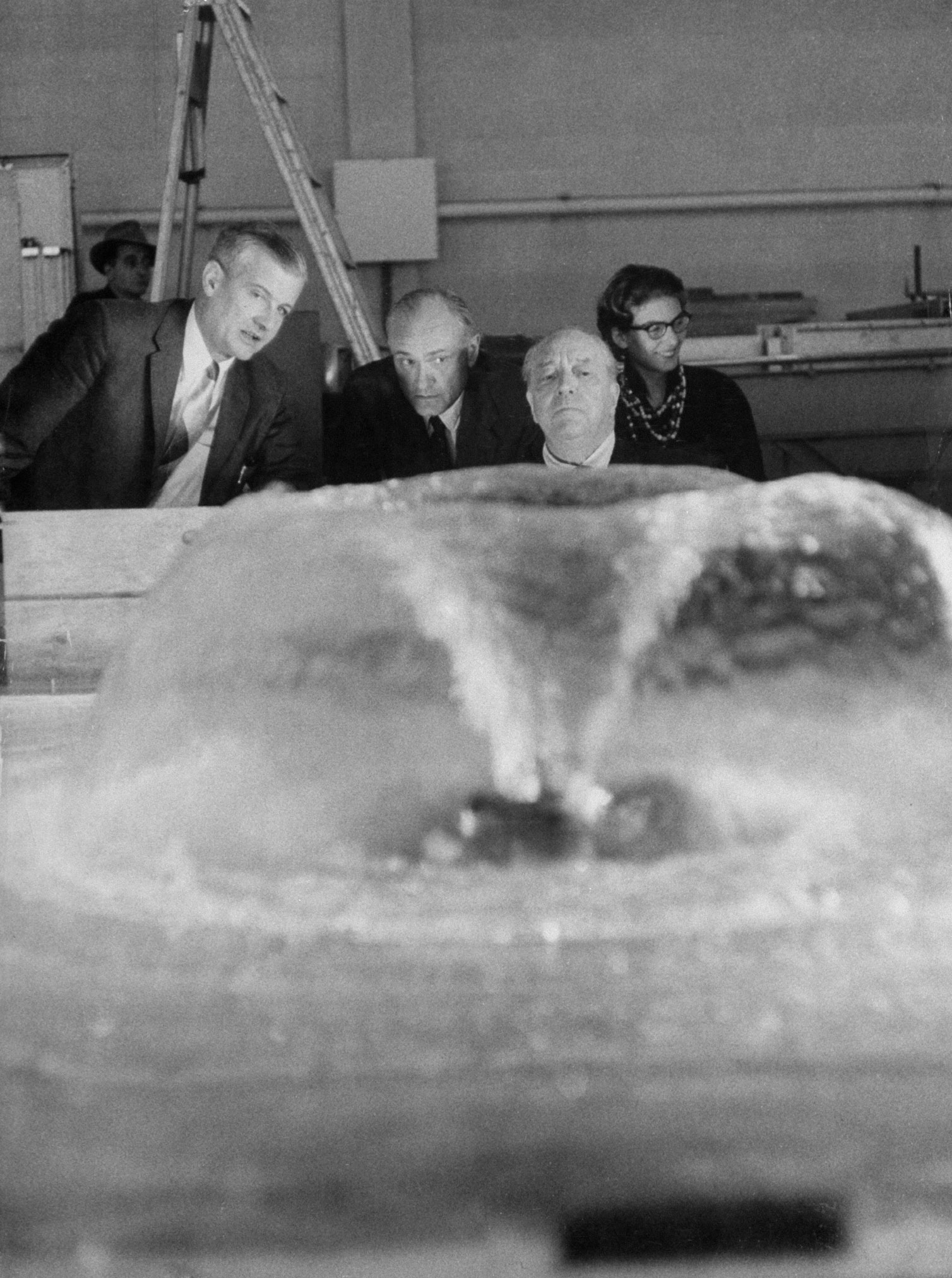 Testing a fountain in a laboratory at Massachusetts Institute of Technology, Mies and his Seagram associate, architect Philip Johnson (second from left), who planned fountain, decide to use two of them to decorate Seagram Plaza.