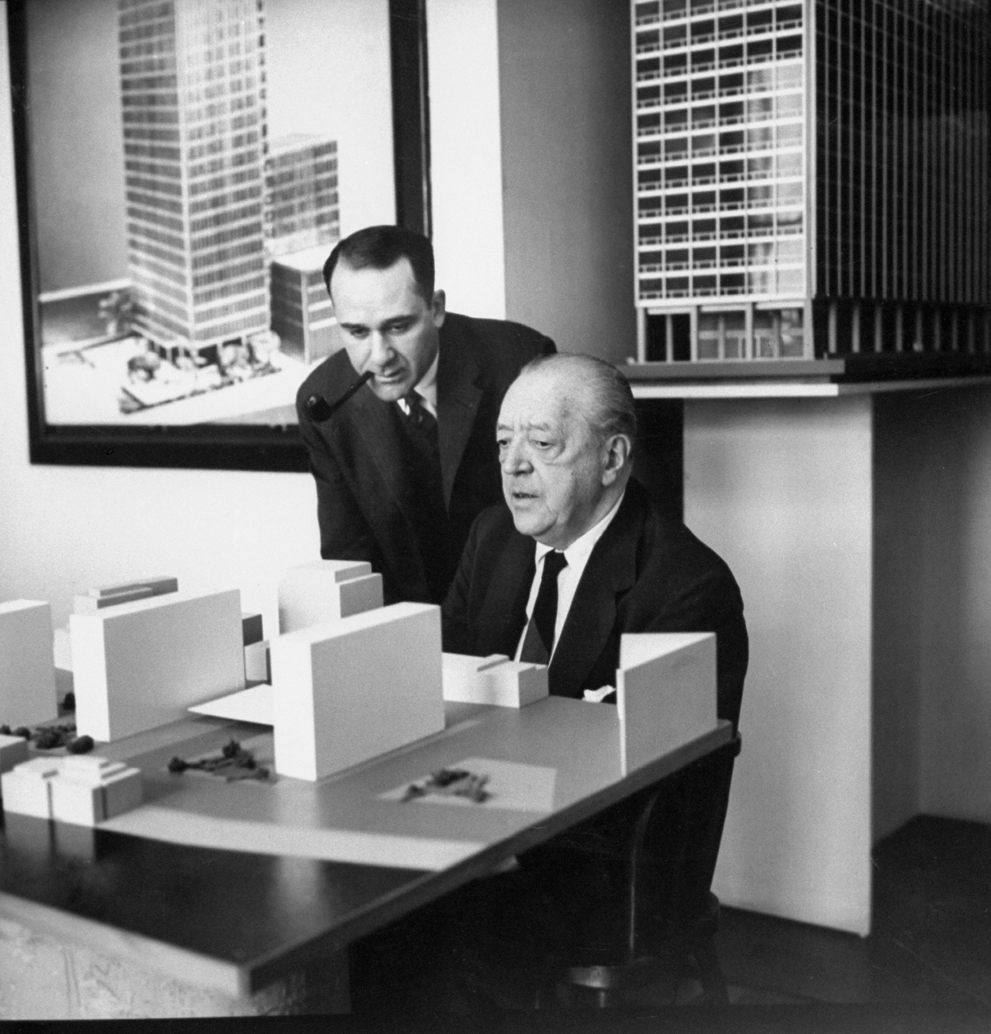 00957887.JPGPlanning new project to remake Battery park, Mies discusses model with Herbert Greenwald, a real estate developer. Greenwald gave Mies his first Chicago apartments commission, now devotes himself to promoting Mies projects