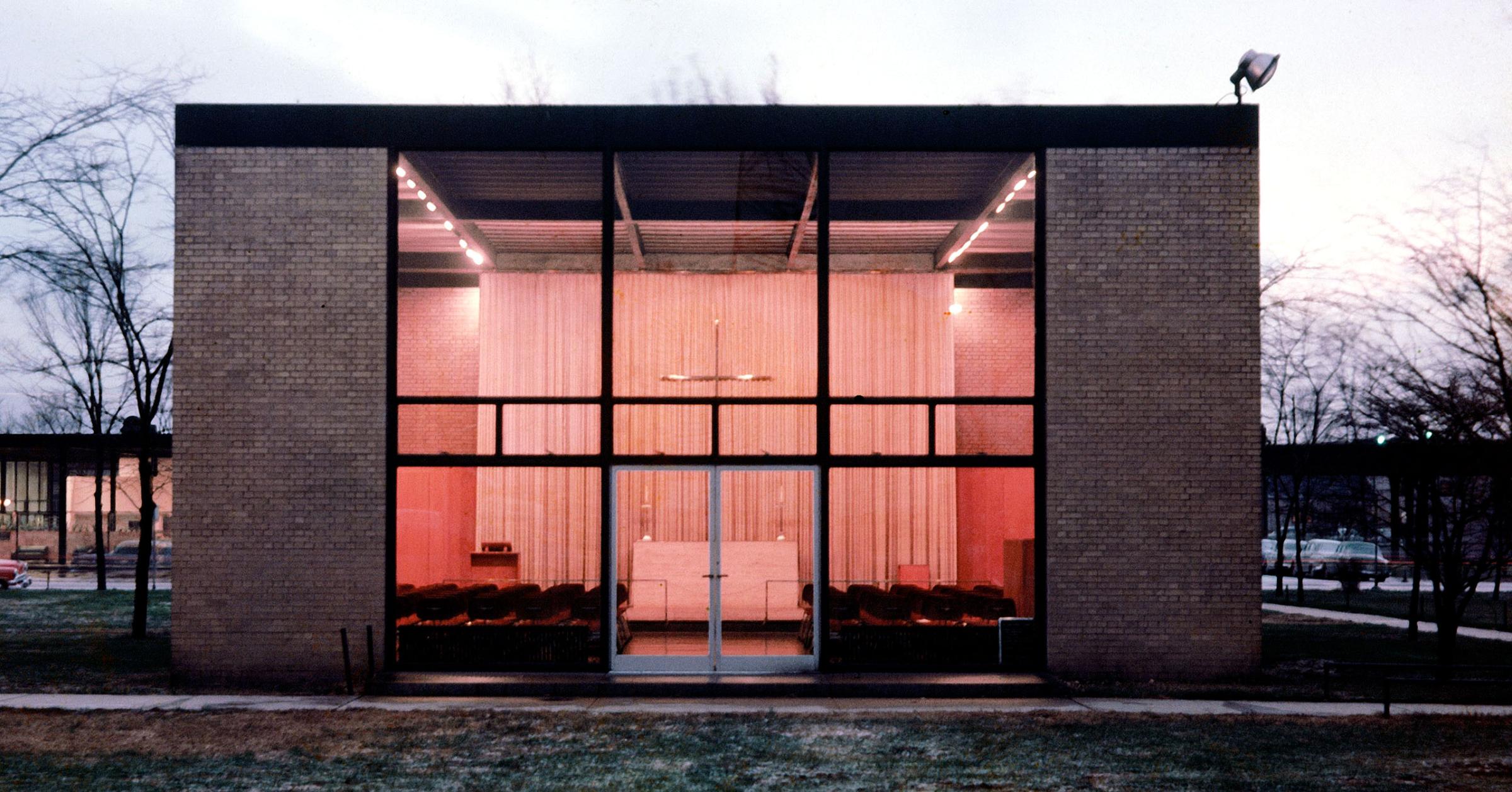Spiritual simplicity was Mies' aim in designing the Illinois Tech Chapel. Maintaining the basic campus pattern, he insisted on flat-roofed rectangle but provided brick walls to give the chapel a sense of privacy and solitude. Steel mullions of the facade echo shape of the cross above the altar