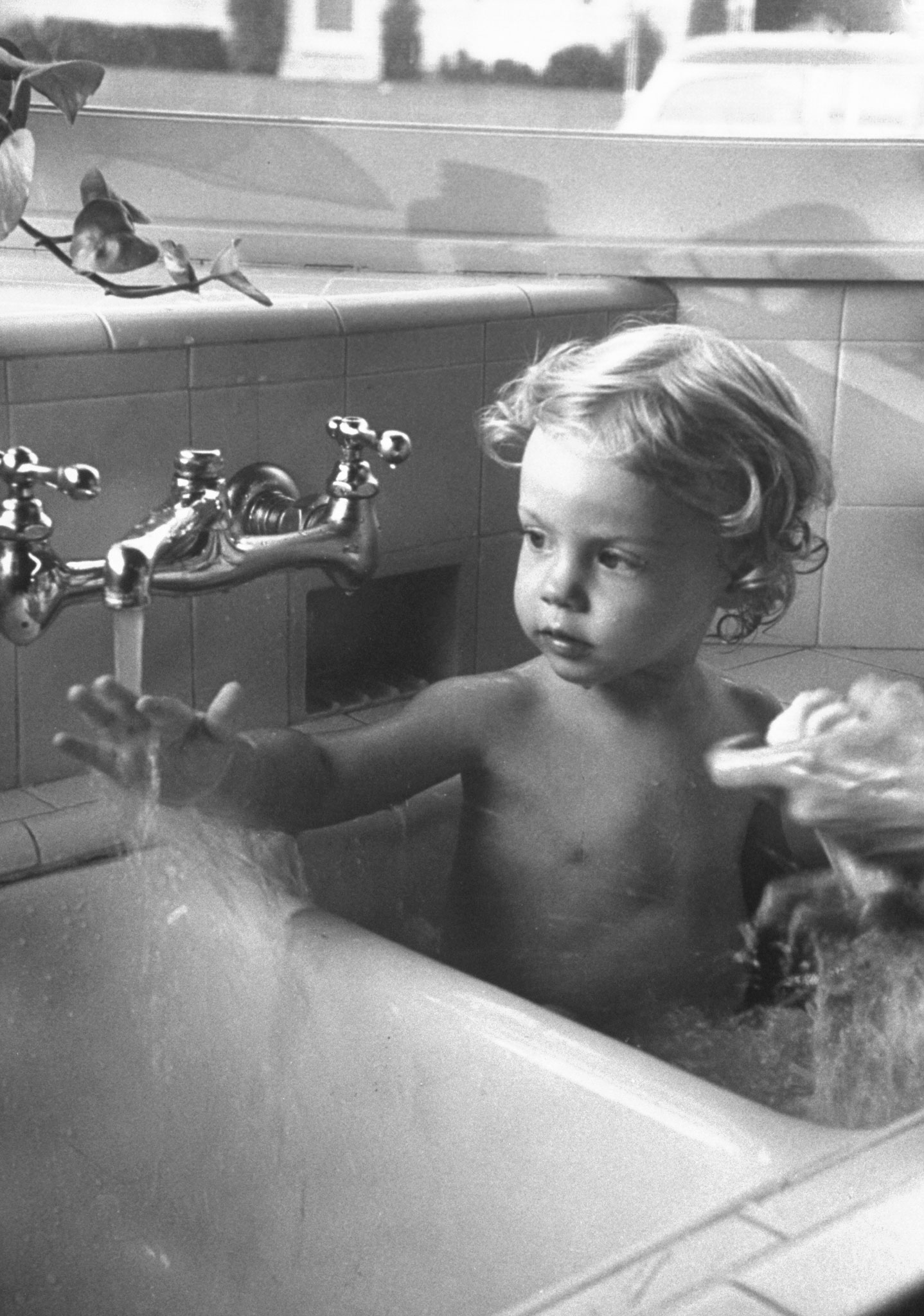 Linda Joy Young bathes in a sink, Pasadena, Calif., in 1951.