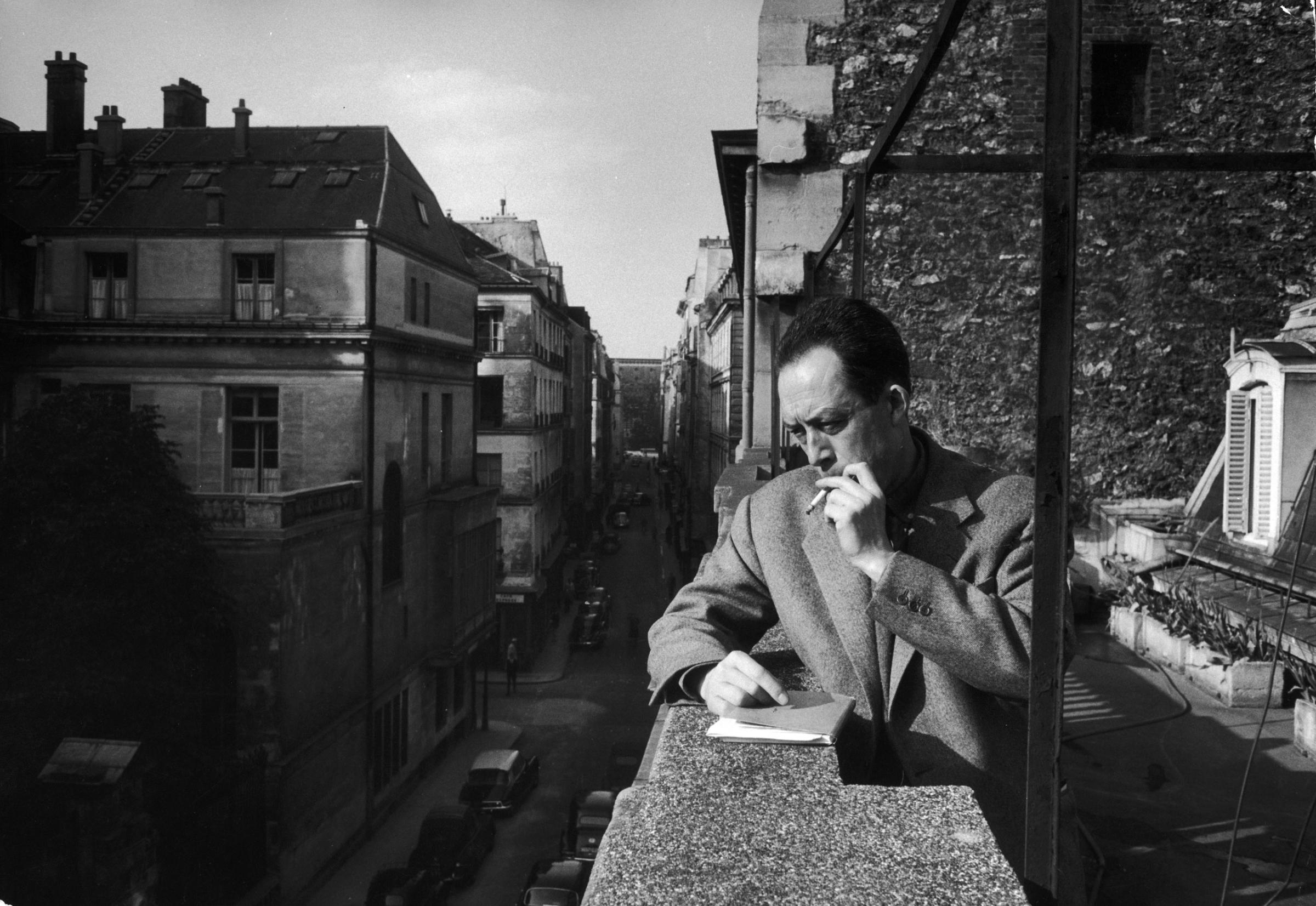 French writer Albert Camus smokes a cigarette on the balcony outside his friend and publisher Michel Gallimard's office in Paris, 1955. Camus won the Nobel in 1957; in 1960, when he was 46 years old, he was killed in a car crash along with Gallimard, who was driving.