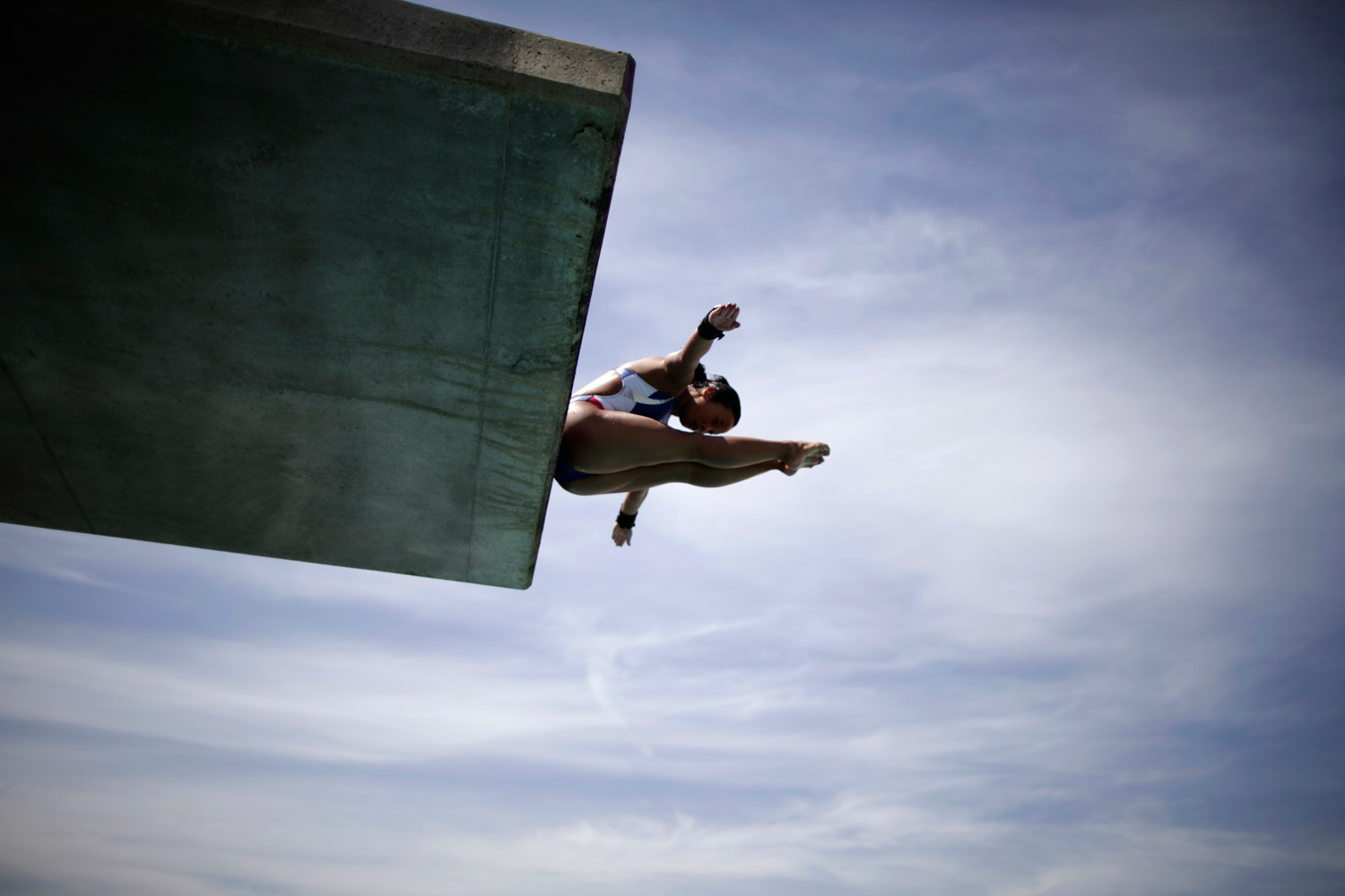 March 28, 2012. U.S. platform diver Haley Ishimatsu dives as she trains for the London 2012 Olympics in Los Angeles.