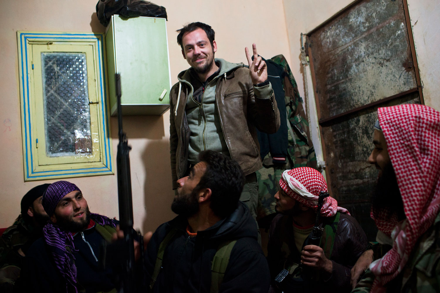 Feb. 21, 2012. Rémi Ochlik with a Free Syrian Army fighter near Homs, taken the night before Ochlik was killed by a rocket attack in Bab Amr.  We met Rémi in this room with all these FSA soldiers ... After that we were inside a tunnel, then we were in Bab Amr,  says Daniels.