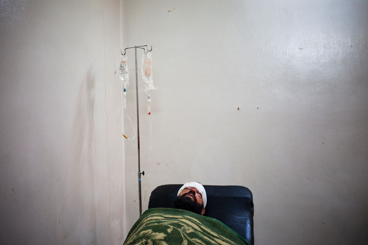 Feb. 23, 2012. A wounded Free Syrian Army member at a clinic in Bab Amr, one day after the attack that killed Rémi Ochlik and Marie Colvin.