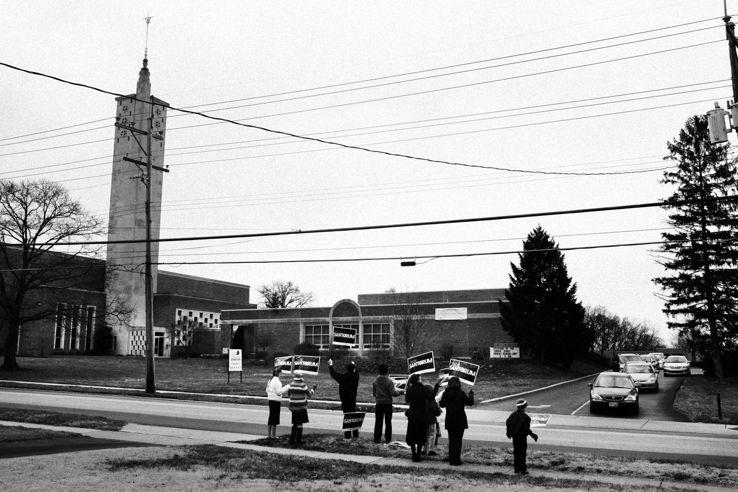 March 4, 2012. Volunteers for the Rick Santorum campaign hold signs in front of St. Gertrude Church after Sunday services in Madeira, Ohio.