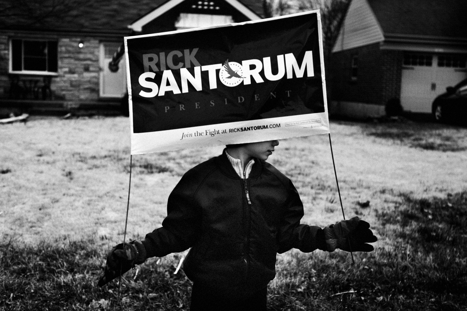 March 4, 2012.  A young volunteer for the Rick Santorum campaign holds a sign in front of St. Gertrude Church in Mason, Ohio.
