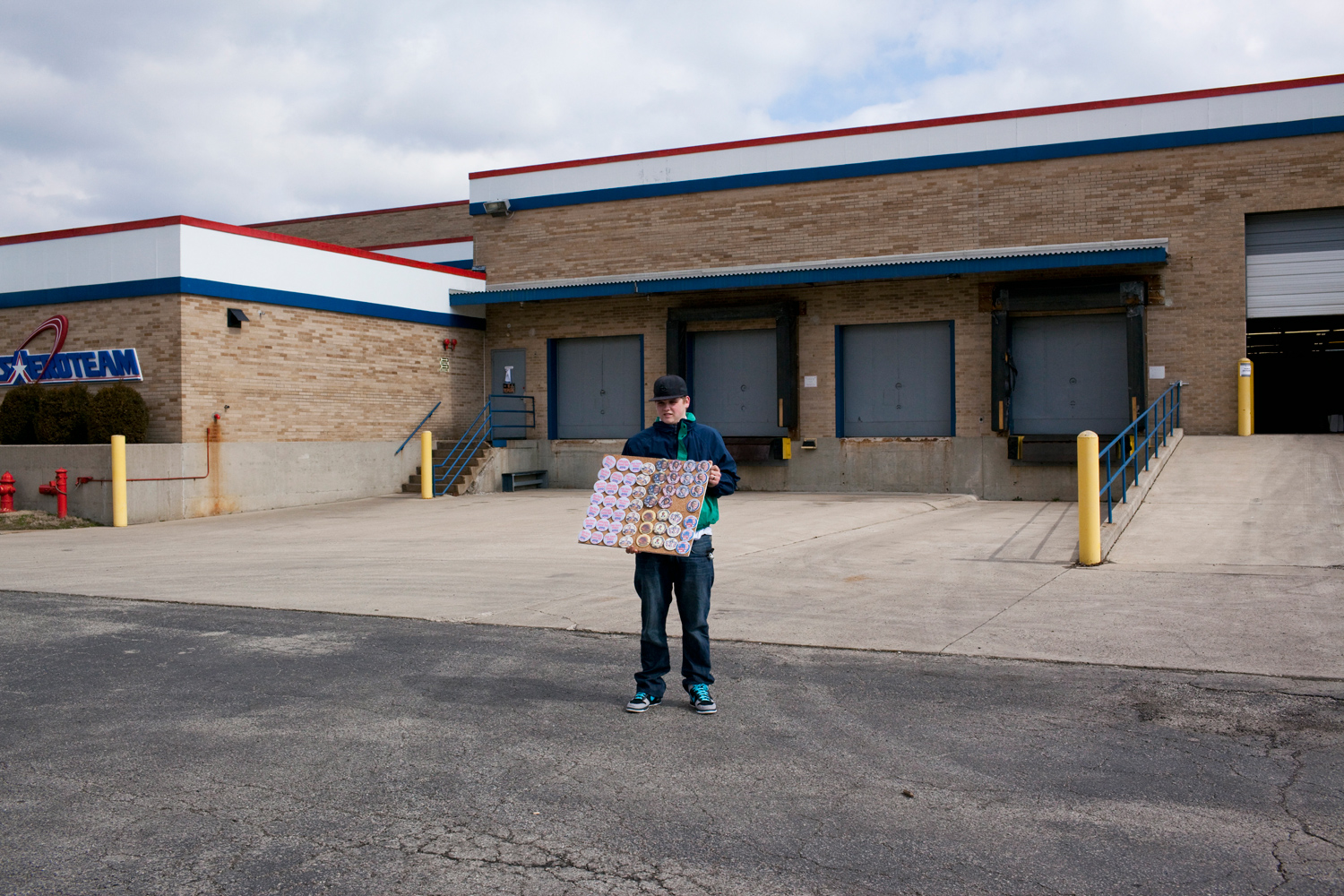 March 3, 2012. Campaign volunteer Ben Mulholland sells buttons outside a rally for Mitt Romney in Dayton, Ohio.