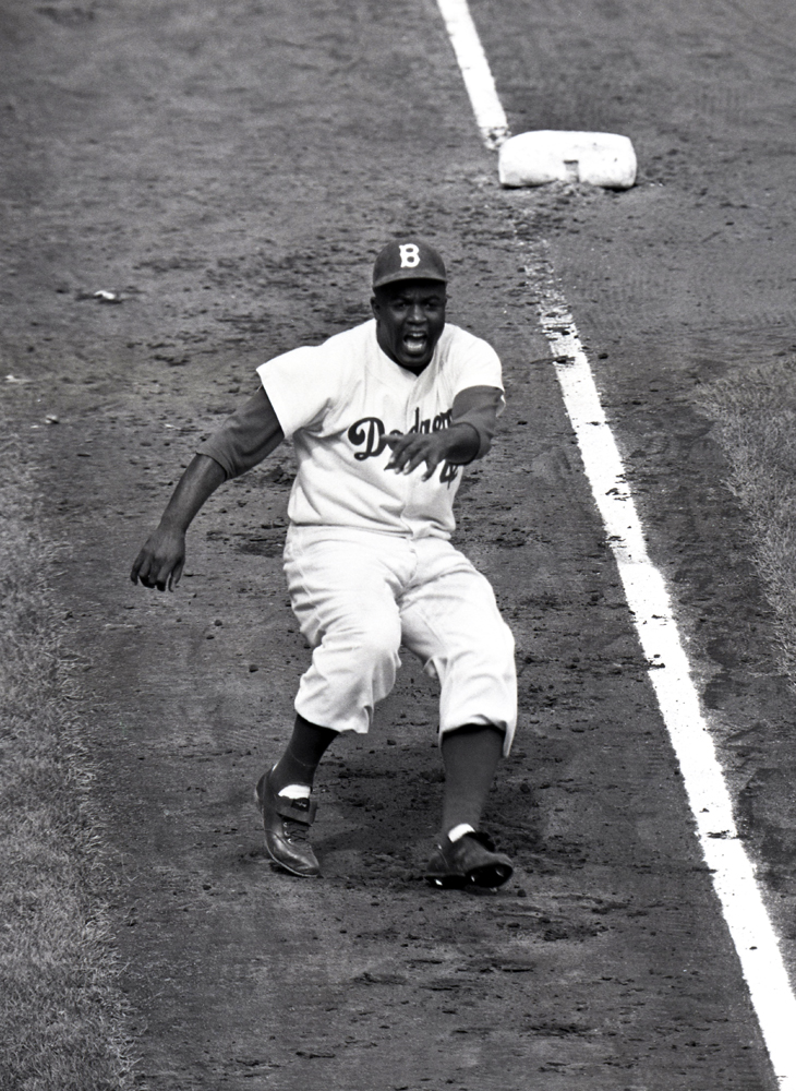 Jackie Robinson, the great disruptor, dances off of third in the 8th inning of Game 3 of the 1955 World Series.