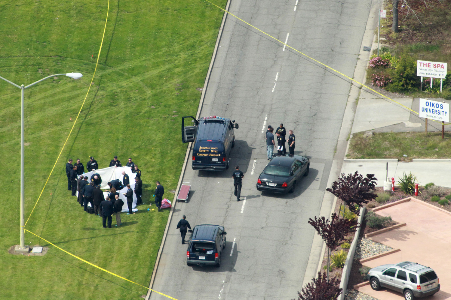 April 2, 2012. Officers from the Alameda County Sheriff Coroner Department remove bodies from outside the Oikos University in Oakland.
