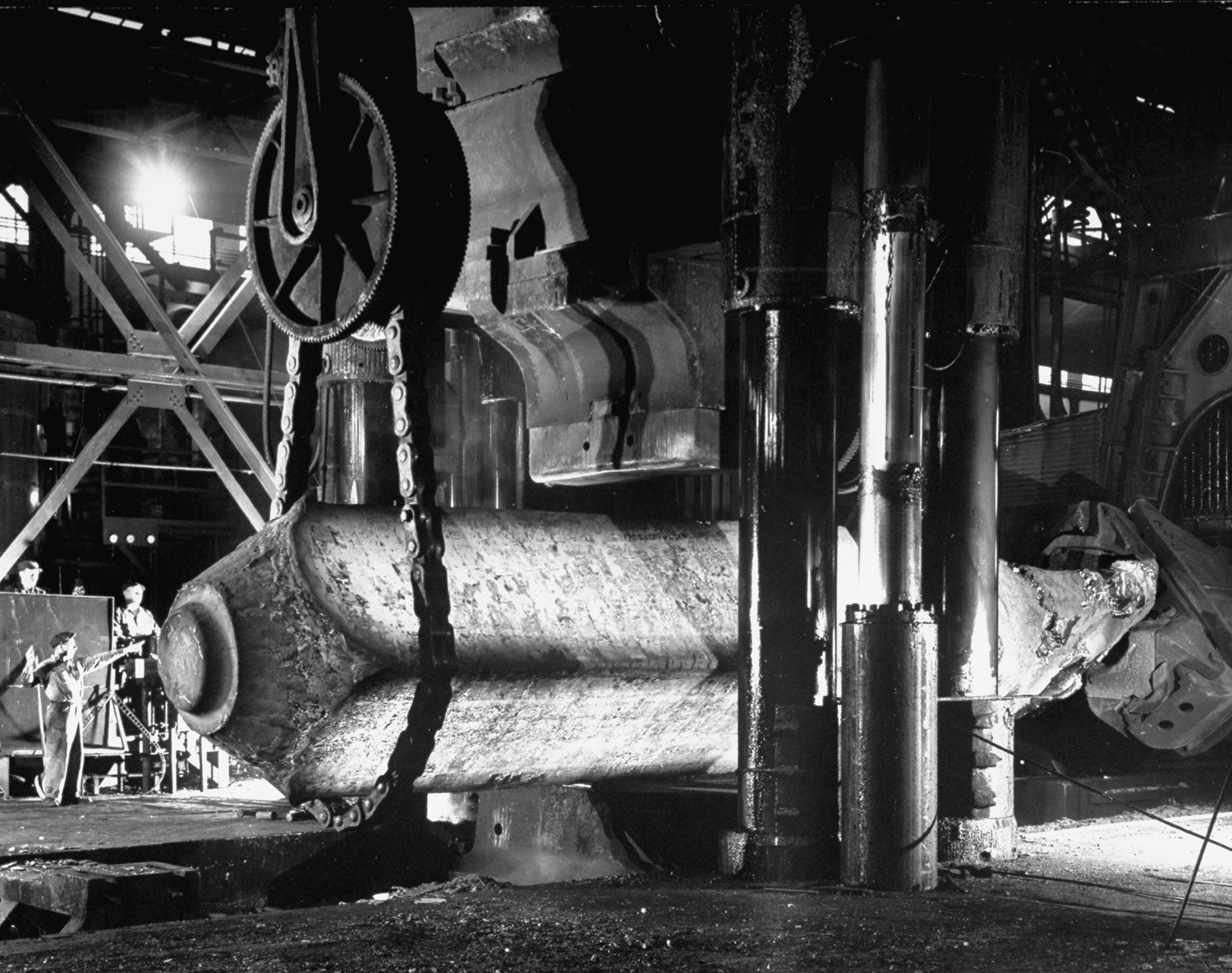 Forging of an enormous steel beam that will be carved into slabs for use in the frame of a cyclotron, Pennsylvania, 1948.