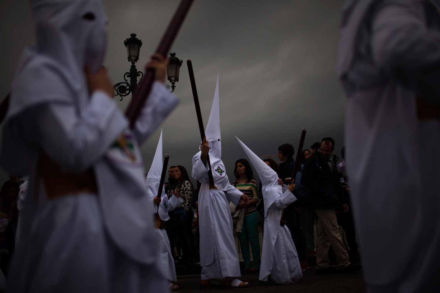 April 2, 2012. Penitents from the  San Gonzalo  brotherhood take part in a procession before a storm in Seville, Spain.