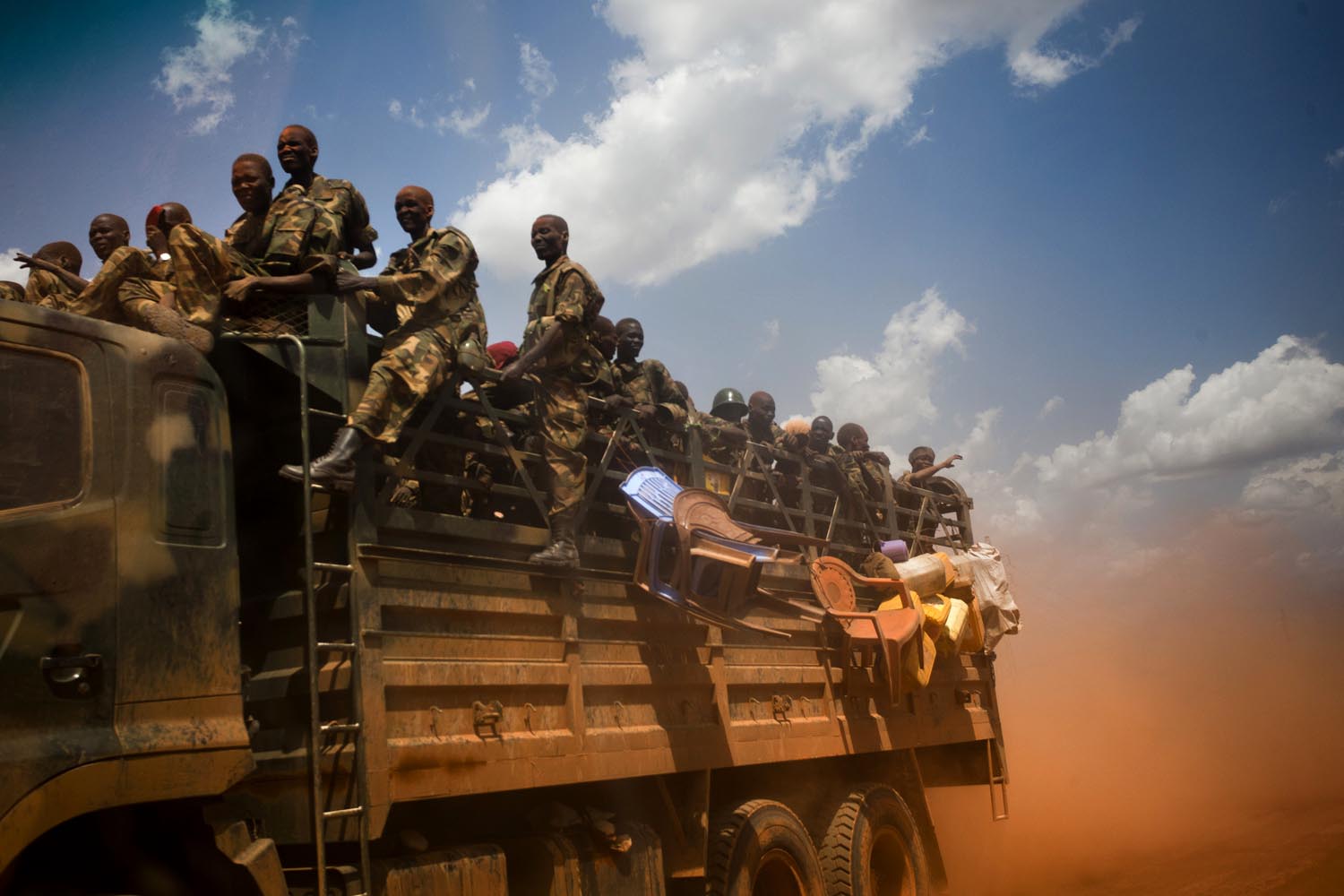 A truck filled with soldiers of the Sudan People's Liberation Army (SPLA), the military force of South Sudan, rushes toward the front line in mid-April.