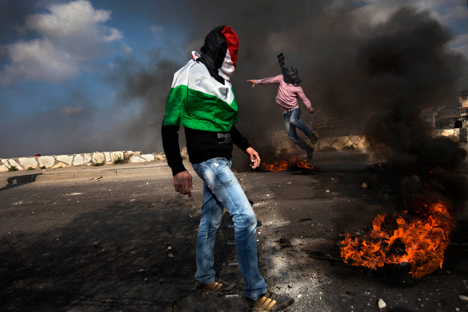 March 30, 2012. Masked Palestinians clash with Israeli troops as they mark the Land Day in the east Jerusalem neighborhood of Issawiyeh.