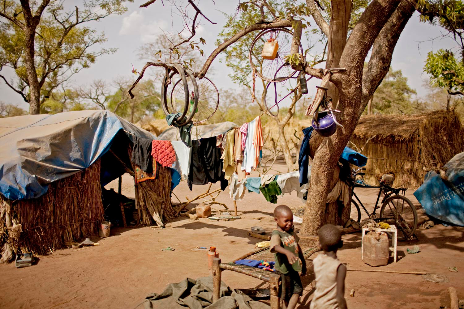 Children play outside of a makeshift hut in the Yida refugee camp.