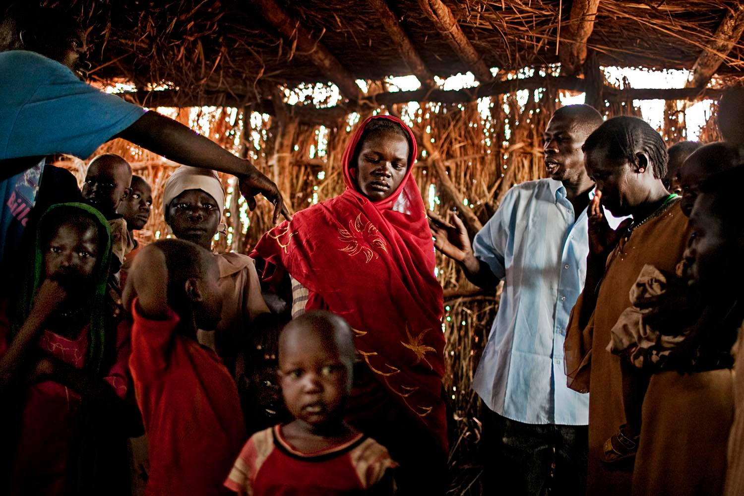A newly arrived Nuba woman and her family wait to be registered at a refugee registration center outside of the Yida refugee camp.