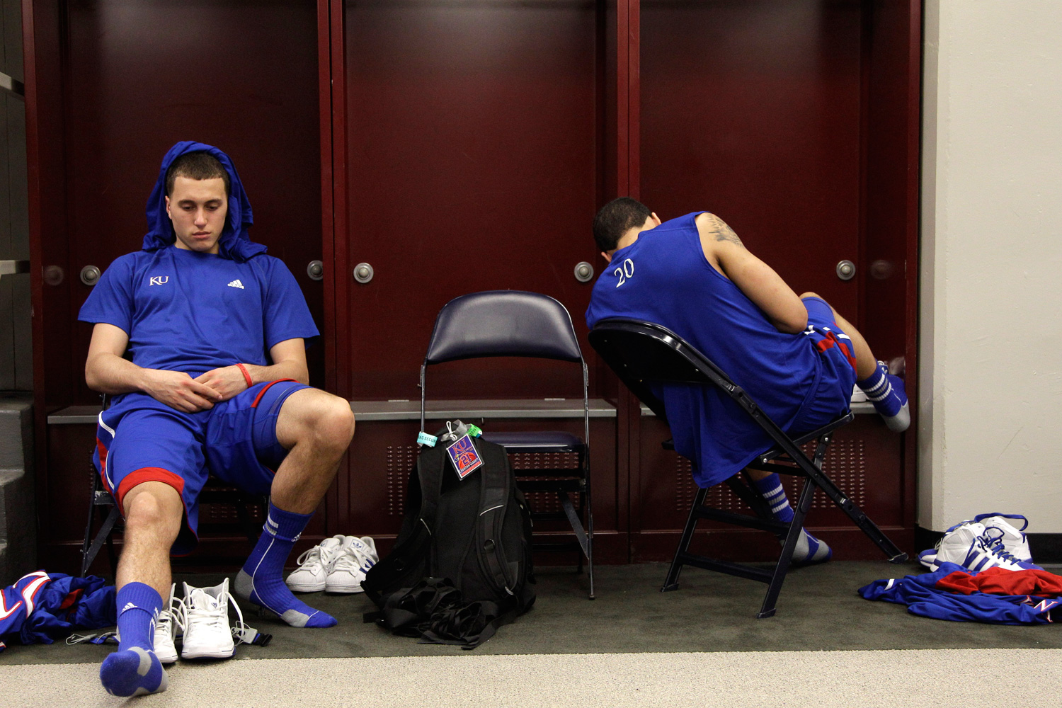 April 2, 2012. Kansas guard Christian Garrett, left, and guard Niko Roberts (20) react in the locker room after their 67-59 loss to Kentucky in the NCAA Final Four tournament college basketball championship game in New Orleans.