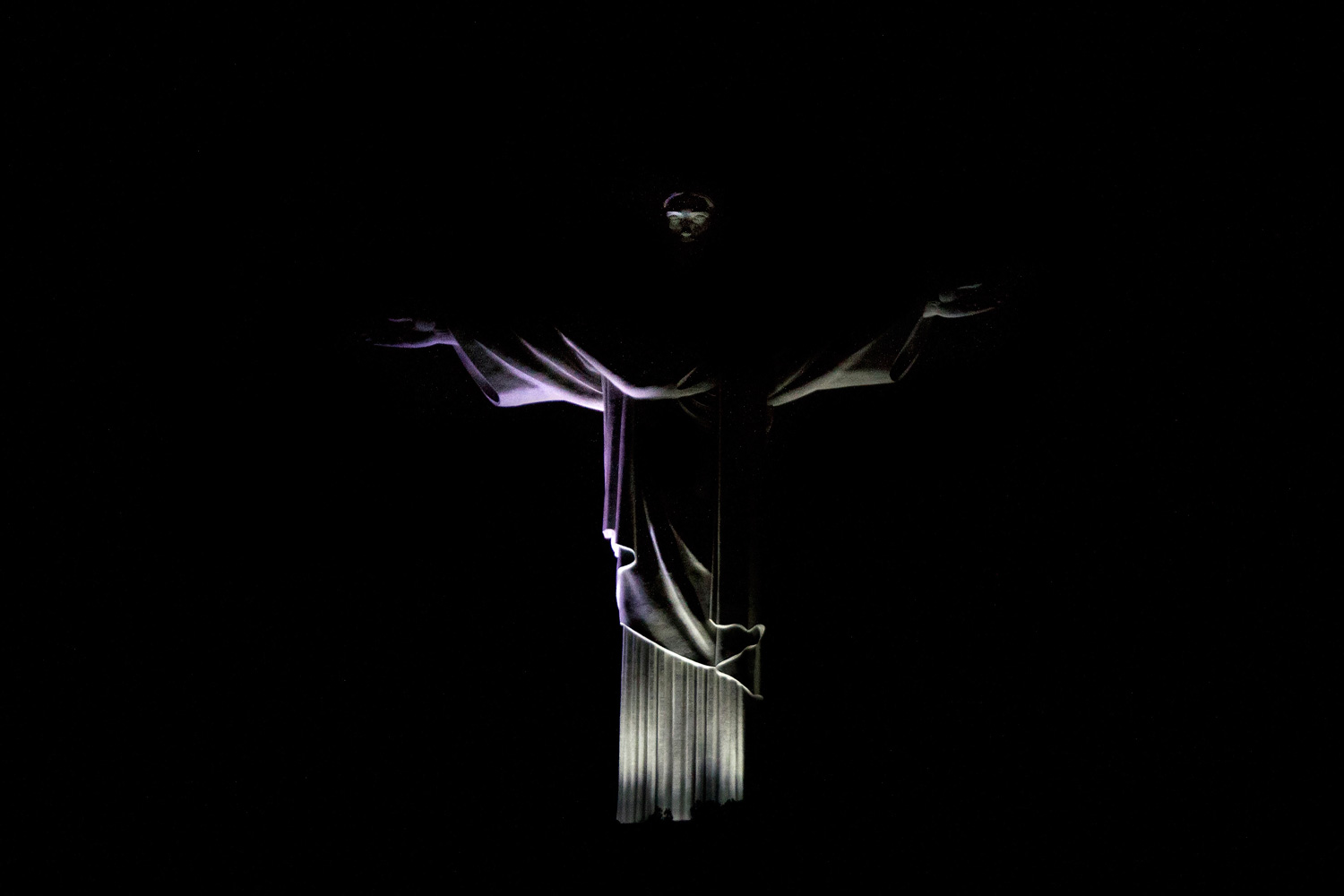 March 31, 2012. The statue of Christ the Redeemer is seen after the lights are switched off for Earth Hour 2012 in Rio de Janeiro.