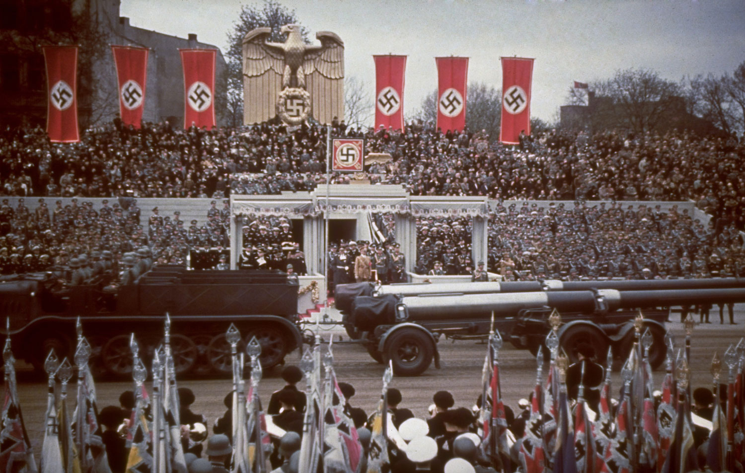 Heavy artillery passes the reviewing stand during a military parade in celebration of Adolf Hitler's 50th birthday, Berlin, April 20, 1939.