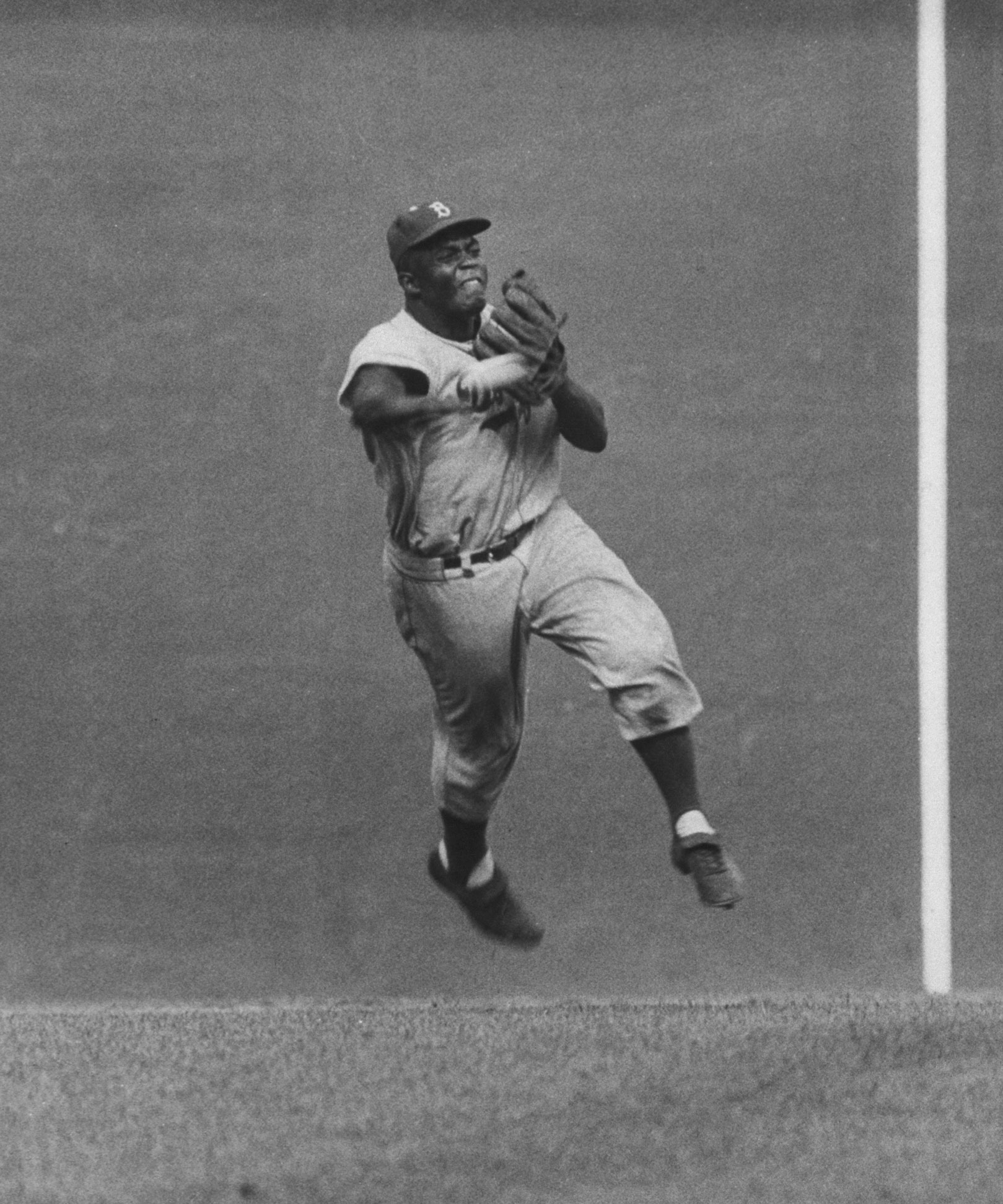 Jackie Robinson in action during game with the Giants, 1956