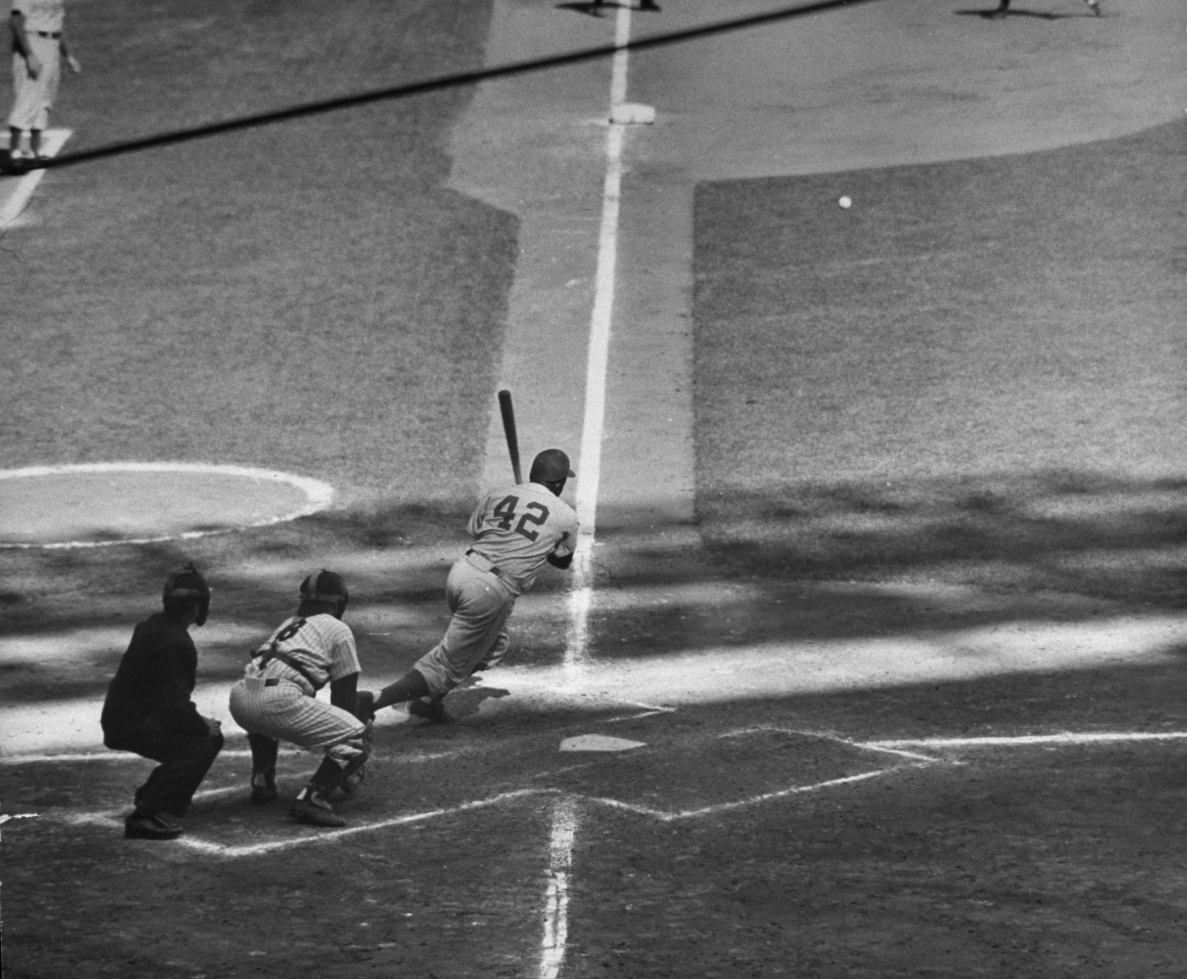 Jackie Robinson slashes a base hit during Game 6 of the 1955 World Series.