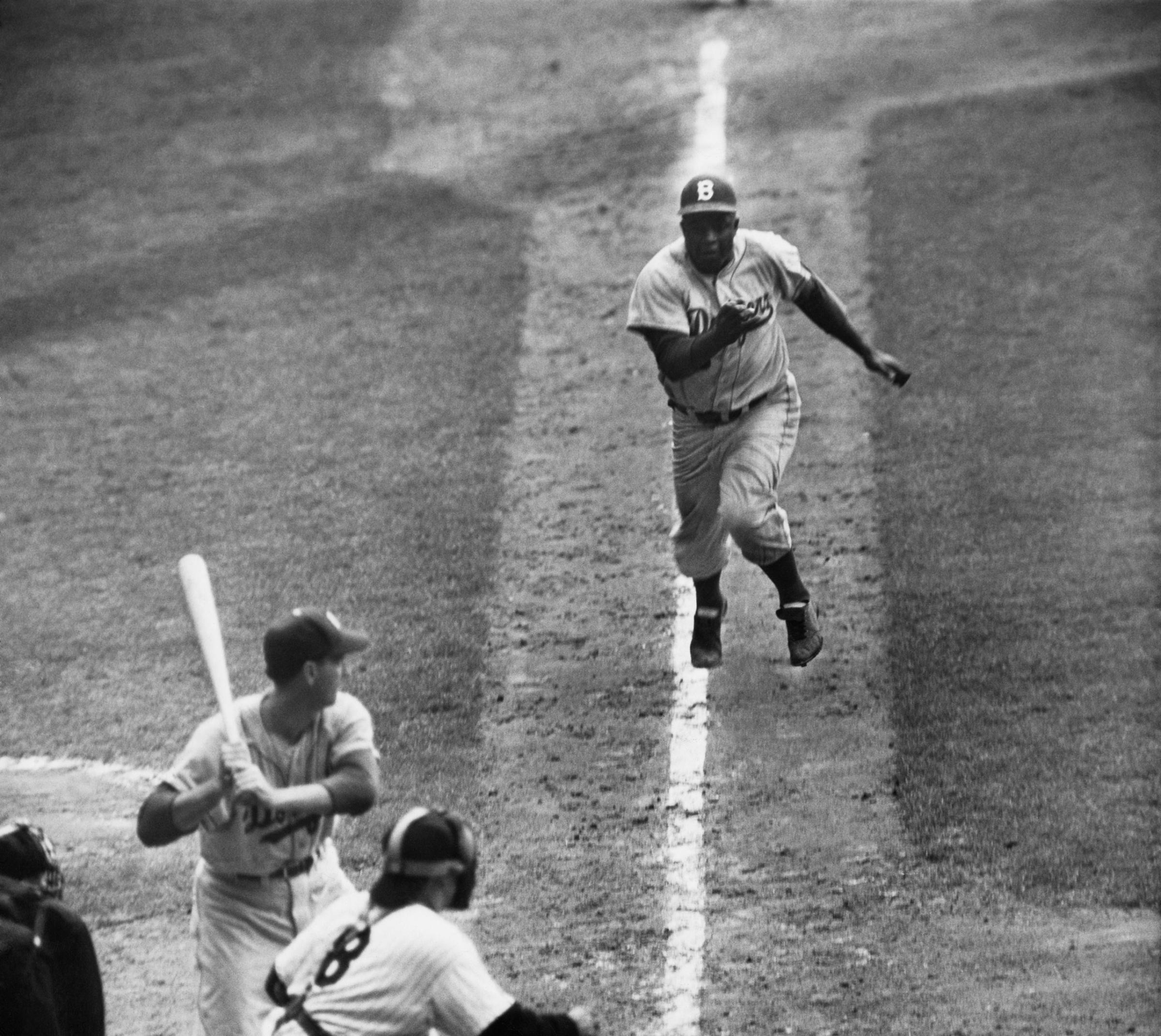 Jackie Robinson stealing home in 1955