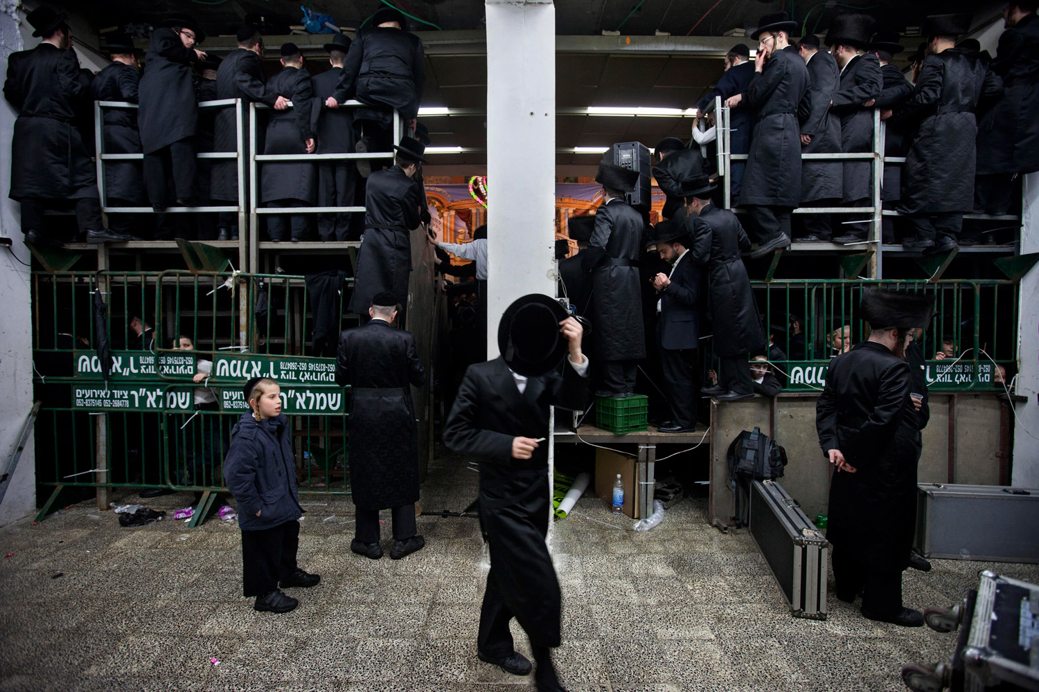 Feb. 16, 2012. Ultra-Orthodox Jewish men crowd together to watch the Sheva Brachot ceremony two days after the traditional Jewish wedding for Chananya Yom Tov Lipa, the great-grandson of the Rabbi of the Wiznitz Hasidic followers, in the ultra-Orthodox town of Bnei Brak near Tel Aviv. The Sheva Brachot in Hebrew, or the seven blessings in English, is a special Jewish wedding blessing.
