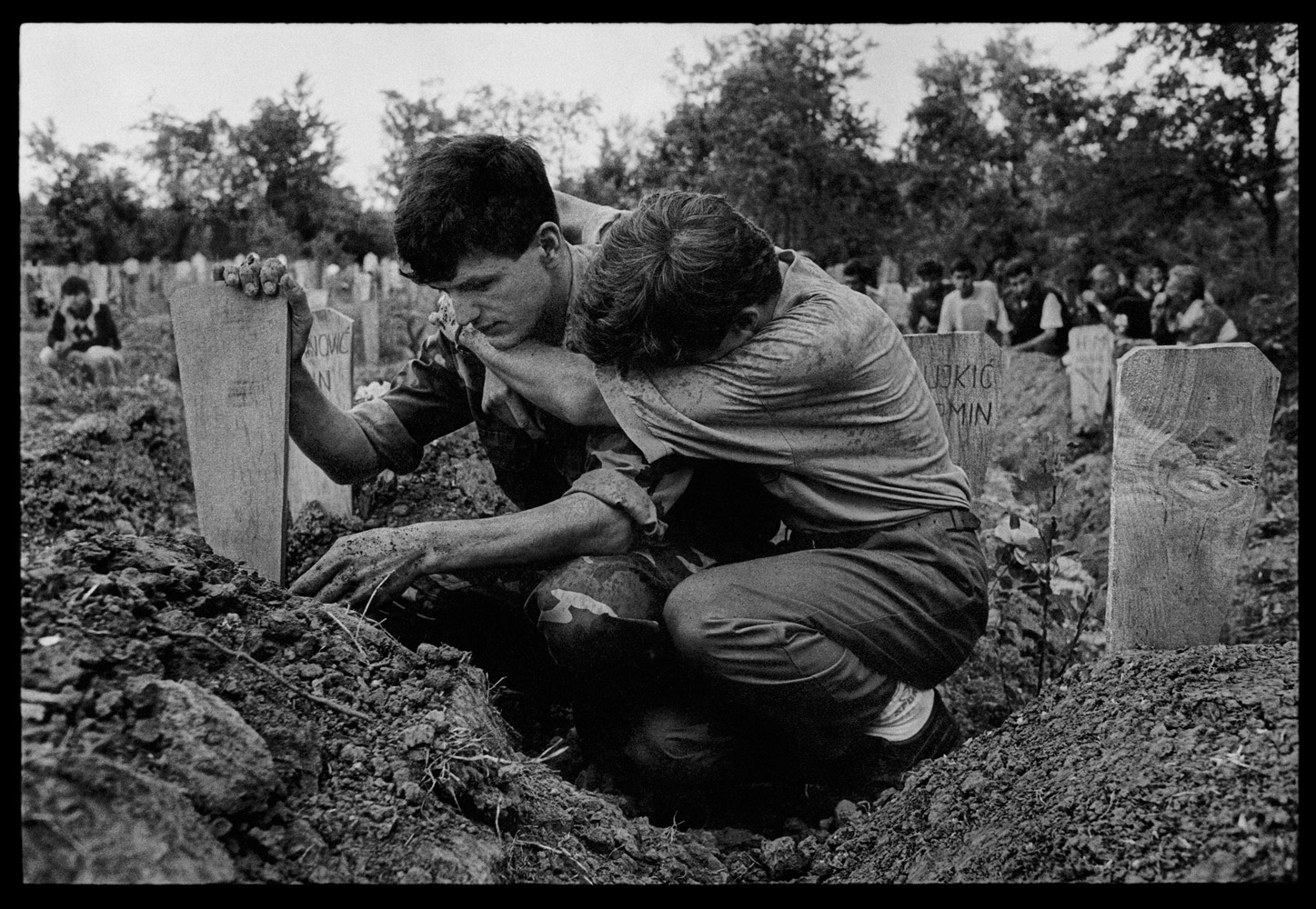 1993. Outside Brcko. In a small Bosnian village outside the town of Brcko, what had once been a park became a cemetery. All of the able, young men in the village were called upon to defend their families and homes from constant attacks by the Serbian army. Battlefield casualties were brought to the local mosque where the villagers would discover which of their relatives or neighbors had died that day.The young Bosnian soldier who guided me to the cemetery said that all of his friends were now buried there. At a funeral, two men collapsed with grief on top of the grave.