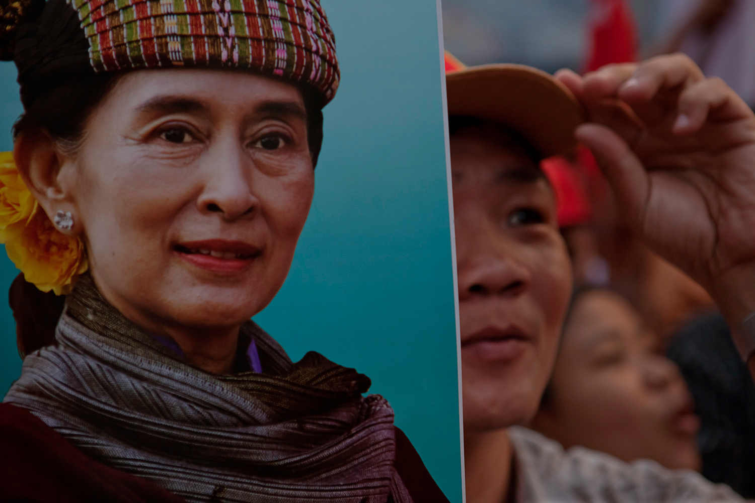 April 1, 2012. While waiting for the vote count at party headquarters, an NLD supporter holds a poster of The Lady dressed in ethnic tribal clothing.