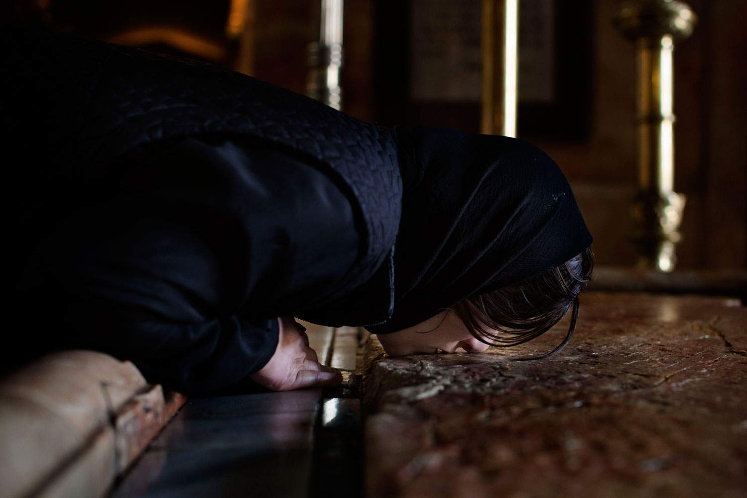 April 5, 2012. A Christian pilgrim kisses the Anointing Stone inside the Church of the Holy Sepulchre, traditionally believed to be the burial site of Jesus Christ, in Jerusalem's Old City.