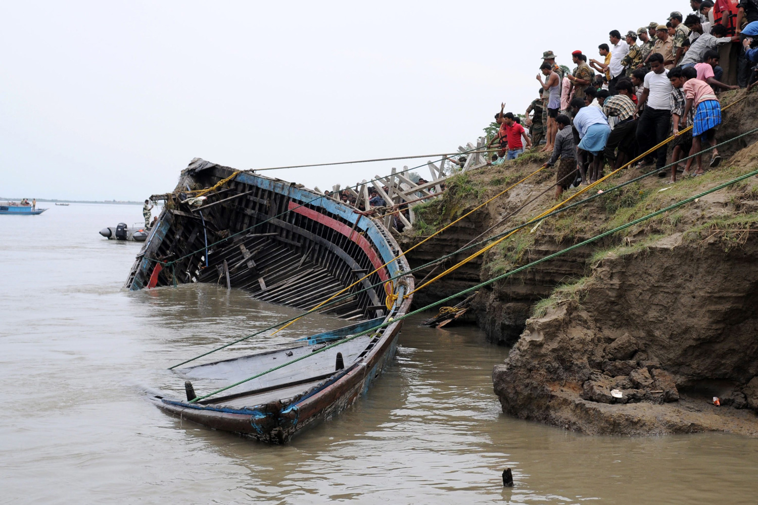 May 1, 2012. Villagers and Border Security Force (BSF) personnel engaged in a rescue operation for a capsized boat at the Brahmaputra River in Bura-Buri village in the Goalpara district of Assam state, northeast India.