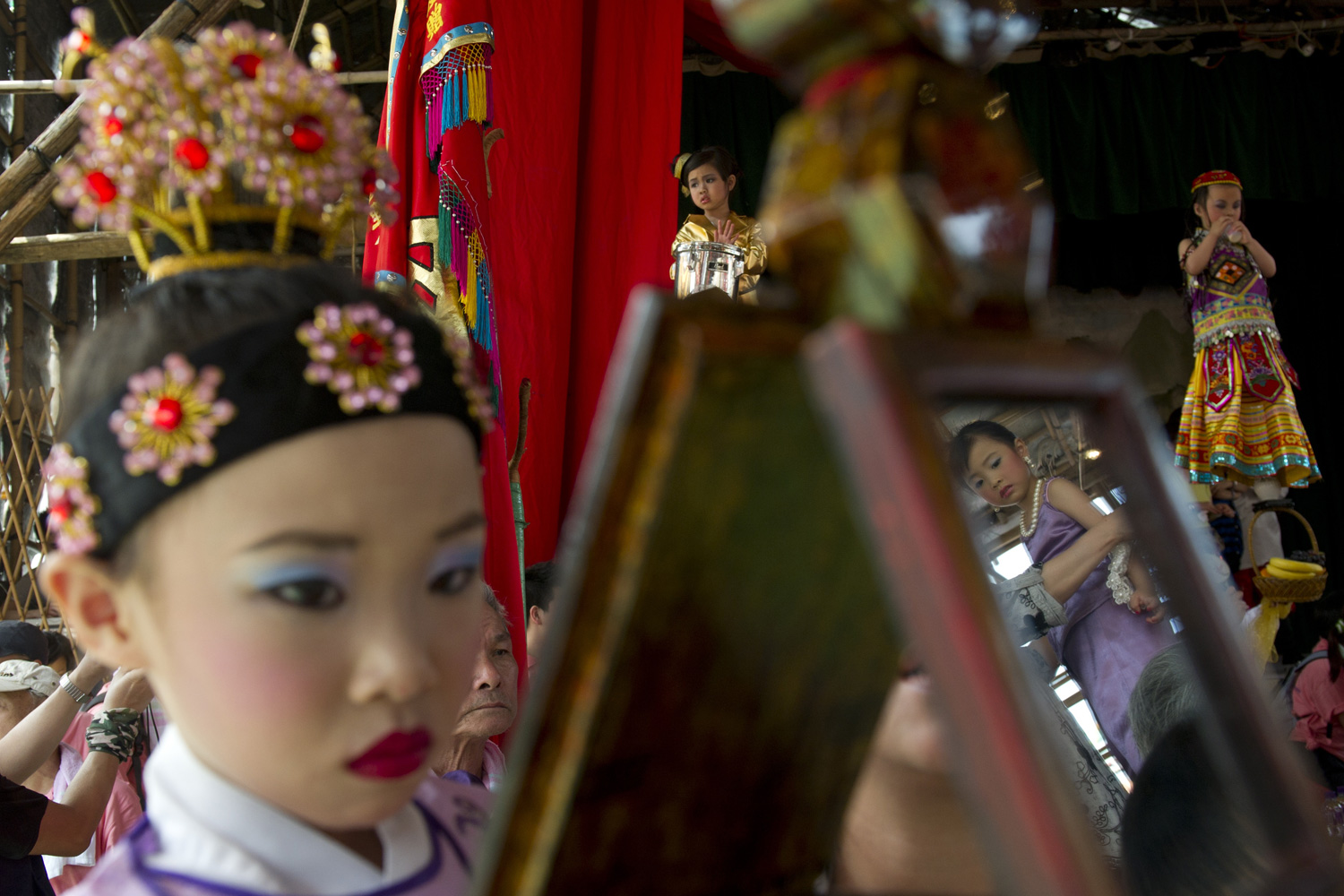 April 28, 2012. Young performers wearing costumes and make-up participate in the Bun Festival parade on Hong Kong's Cheung Chau Island.