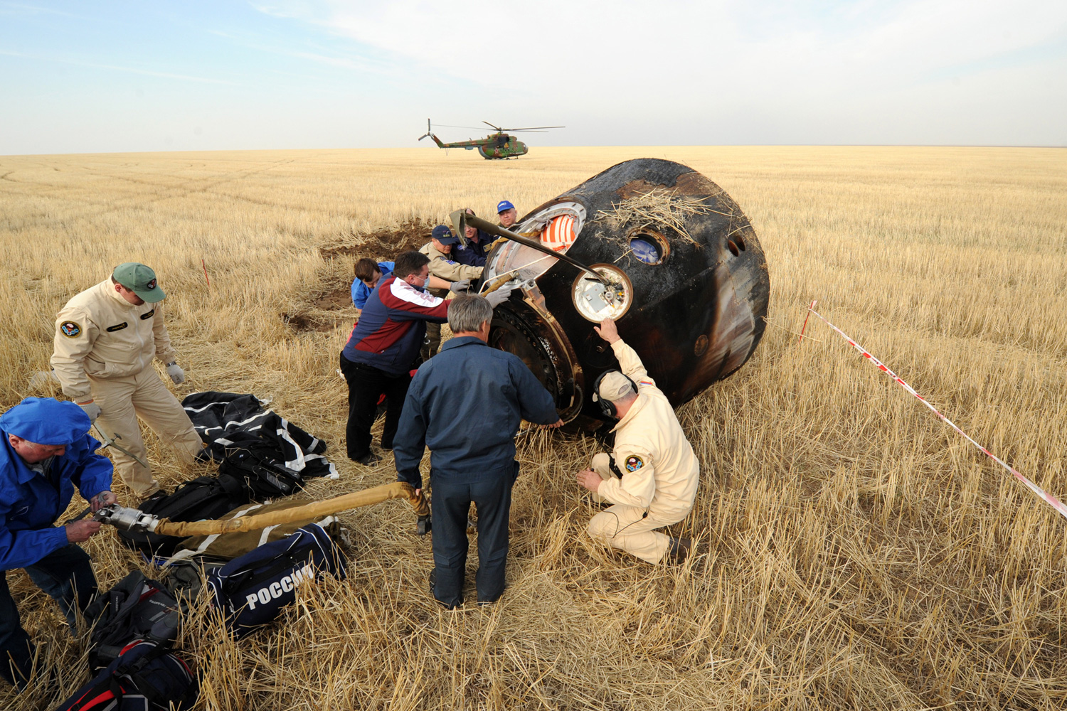 April 27, 2012. Russia's space agency ground personnel check the capsule Soyuz TMA-22 shortly after it landed near the town of Arkalyk, Kazakhstan.