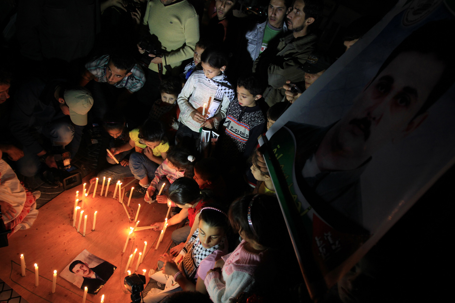 April 28, 2012. Palestinian children place candles on the ground during an evening demonstration in Gaza City calling for the release of Palestinians being held in Israeli jails.