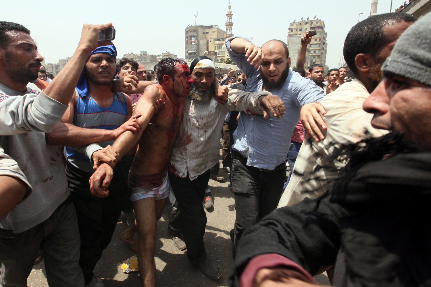 May 2, 2012. Egyptian anti-military protesters arrest one of the rioters who attacked them, during clashes at Abbassiya Square, Cairo.