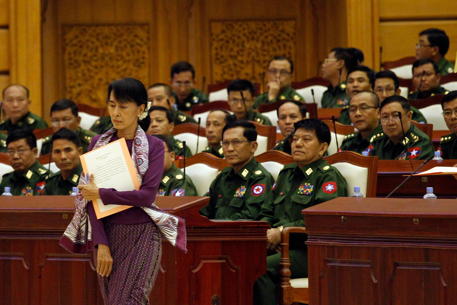 May 2, 2012. Pro-democracy leader Aung San Suu Kyi walks to take an oath at the lower house of parliament in Naypyitaw, Myanmar.