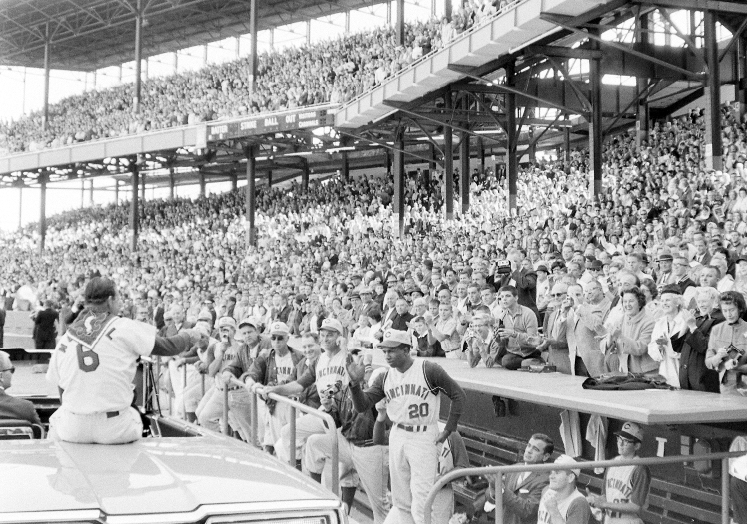 Fans, teammates and opponents (the Cincinnati Reds) applaud Stan Musial as he takes a farewell ride around the ballpark on his last day in the majors, September 29, 1963.