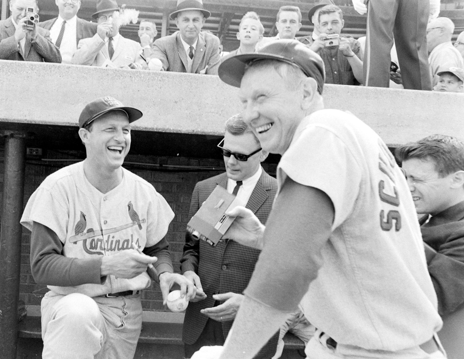 Stan Musial and his old friend and long-time Cardinal, Red Schoendienst (right, with movie camera in hand) on Musial's last day in the majors, 1963.