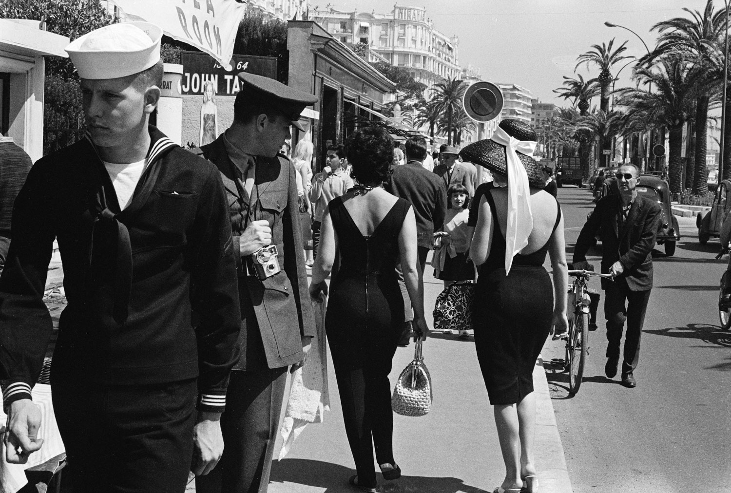 An American serviceman admires passersby in Cannes, 1962.
