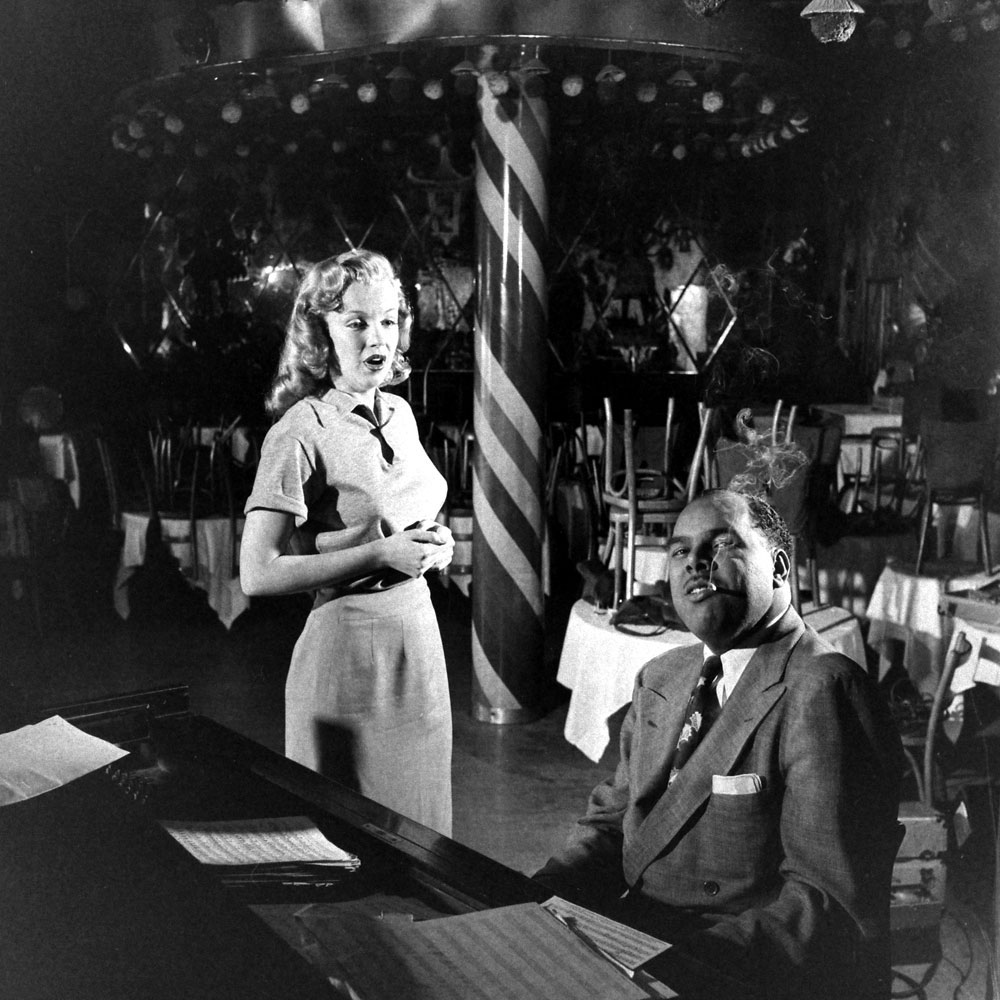 Marilyn Monroe, 22, takes singing lessons with bandleader Phil Moore at the famous West Hollywood nightclub, the Mocambo.