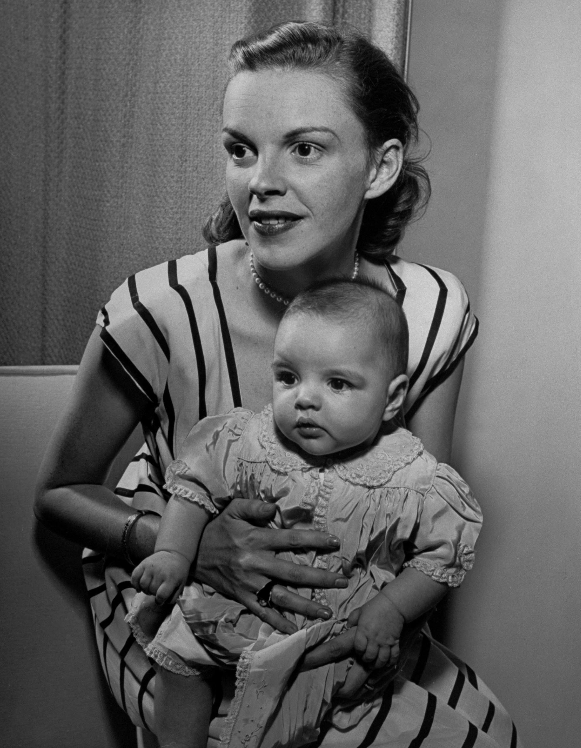 Judy Garland holds her daughter, Liza, at home in Hollywood in 1946.