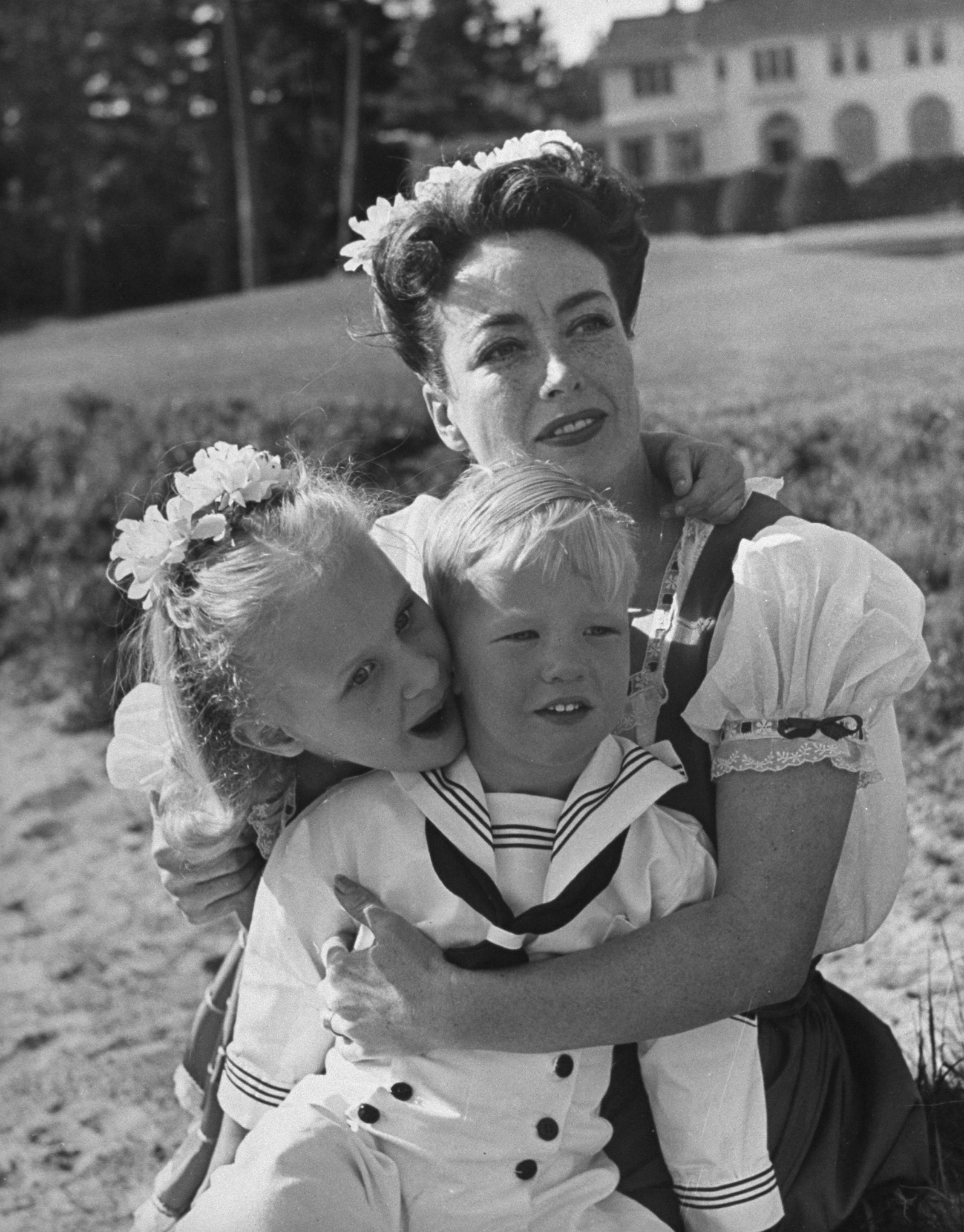 Actress Joan Crawford and her two adopted children on the beach, Monterey, California, 1945.