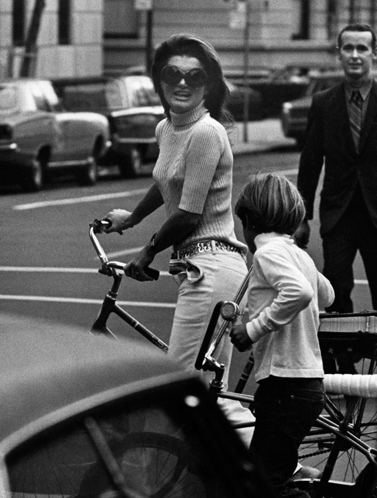 Jacqueline Kennedy Onassis and John Jr. ride bikes in Central Park. Sept. 24, 1969