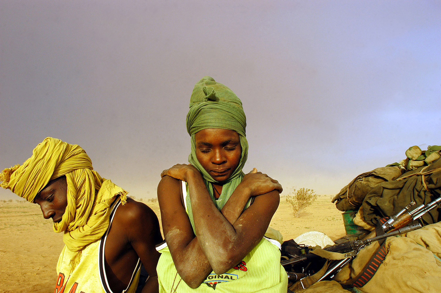 Masters Talk ArtistAug. 21, 2004. Soldiers with the Sudanese Liberation Army sit by their truck while struck in the mud in Darfur, Sudan.