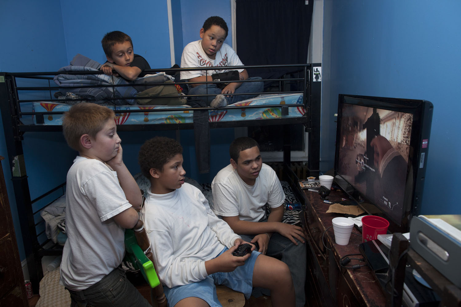 Donny watches as his uncle Little John and his friends play Call of Duty.