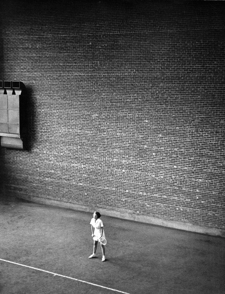 A Vassar student waits to return a serve in 1937.