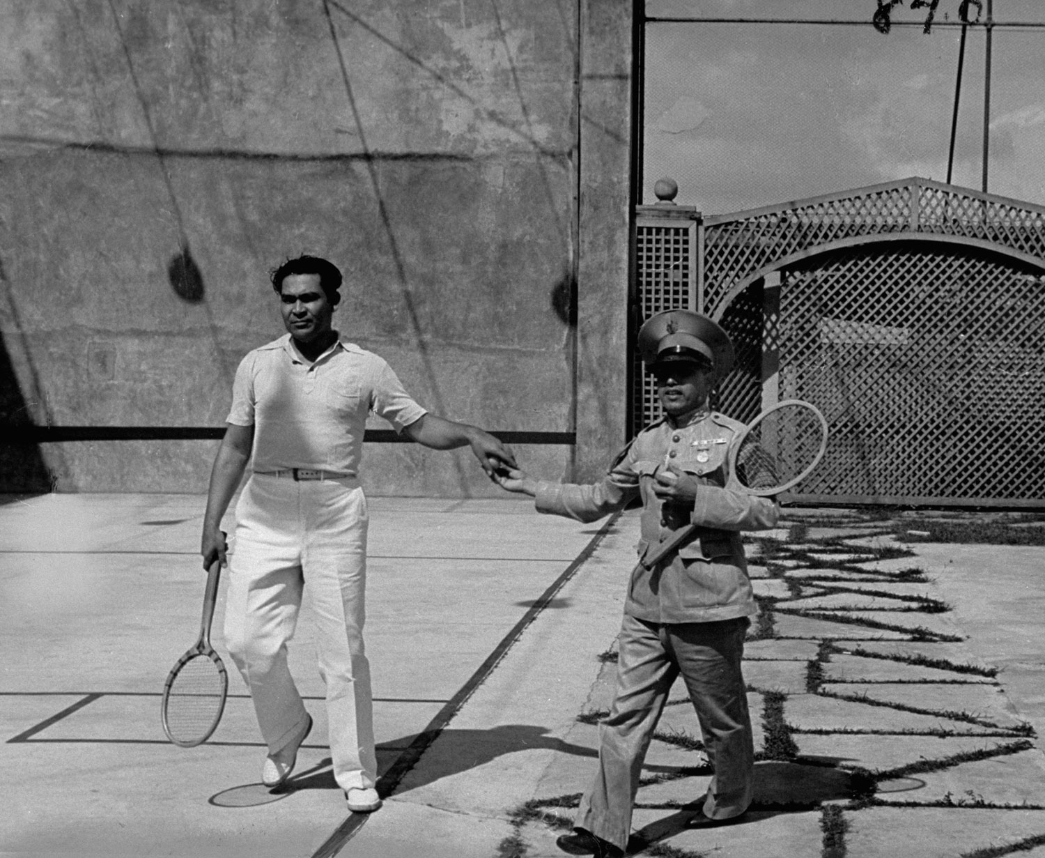 An aide hands Col. Fulgencio Batista, future president and dictator of Cuba, a tennis ball in 1938 Cuba.