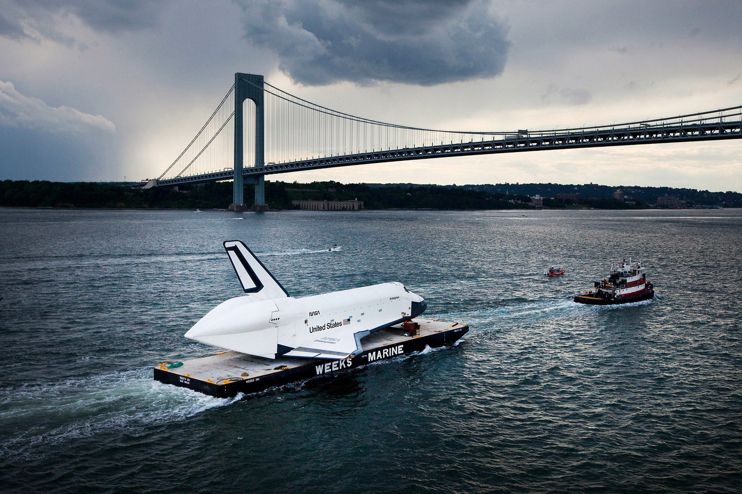 June 3, 2012. The space shuttle Enterprise is carried by barge underneath the Verrazano-Narrows Bridge in New York City.  Enterprise is on its way to the Intrepid Sea, Air and Space Museum, where it will be put on permanent display.
