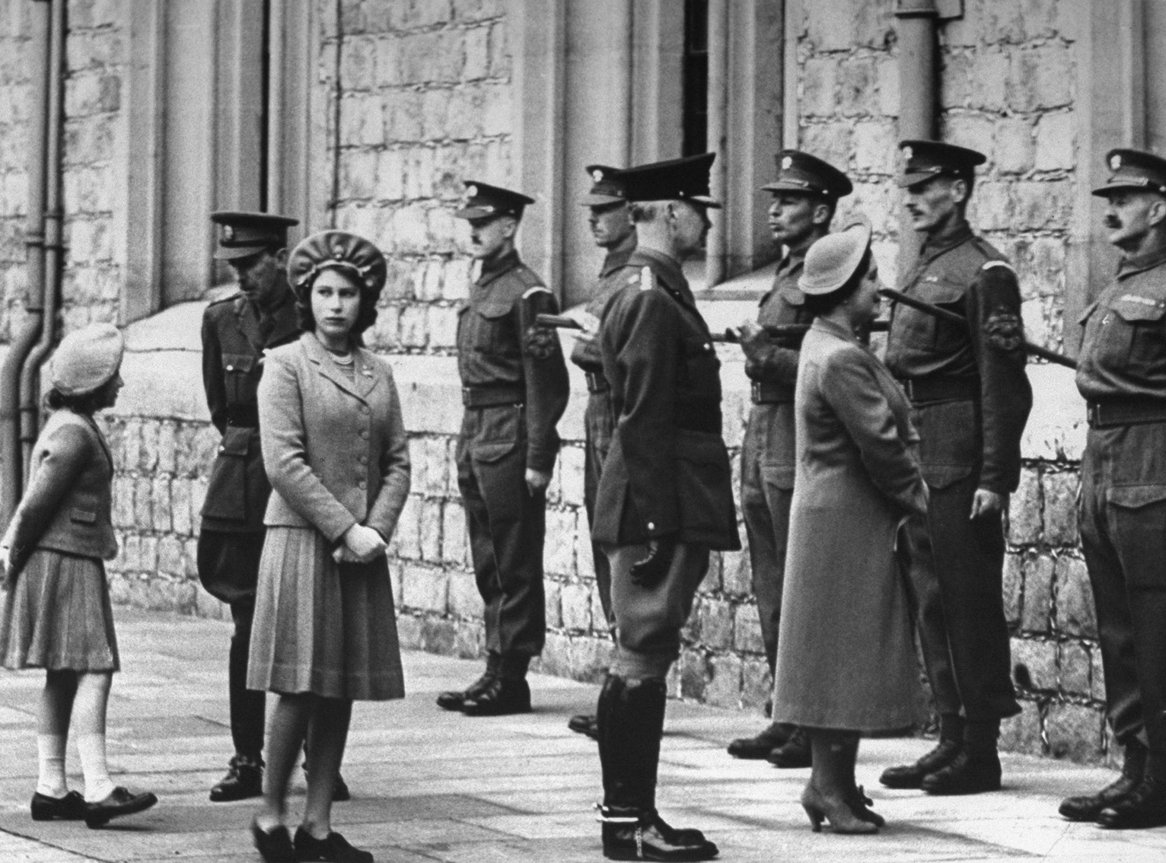 Princess Margaret (left), Princess Elizabeth (third from left) and the Queen (third from right) with the Grenadier guards on the occasion of Princess Elizabeth's birthday, 1942.